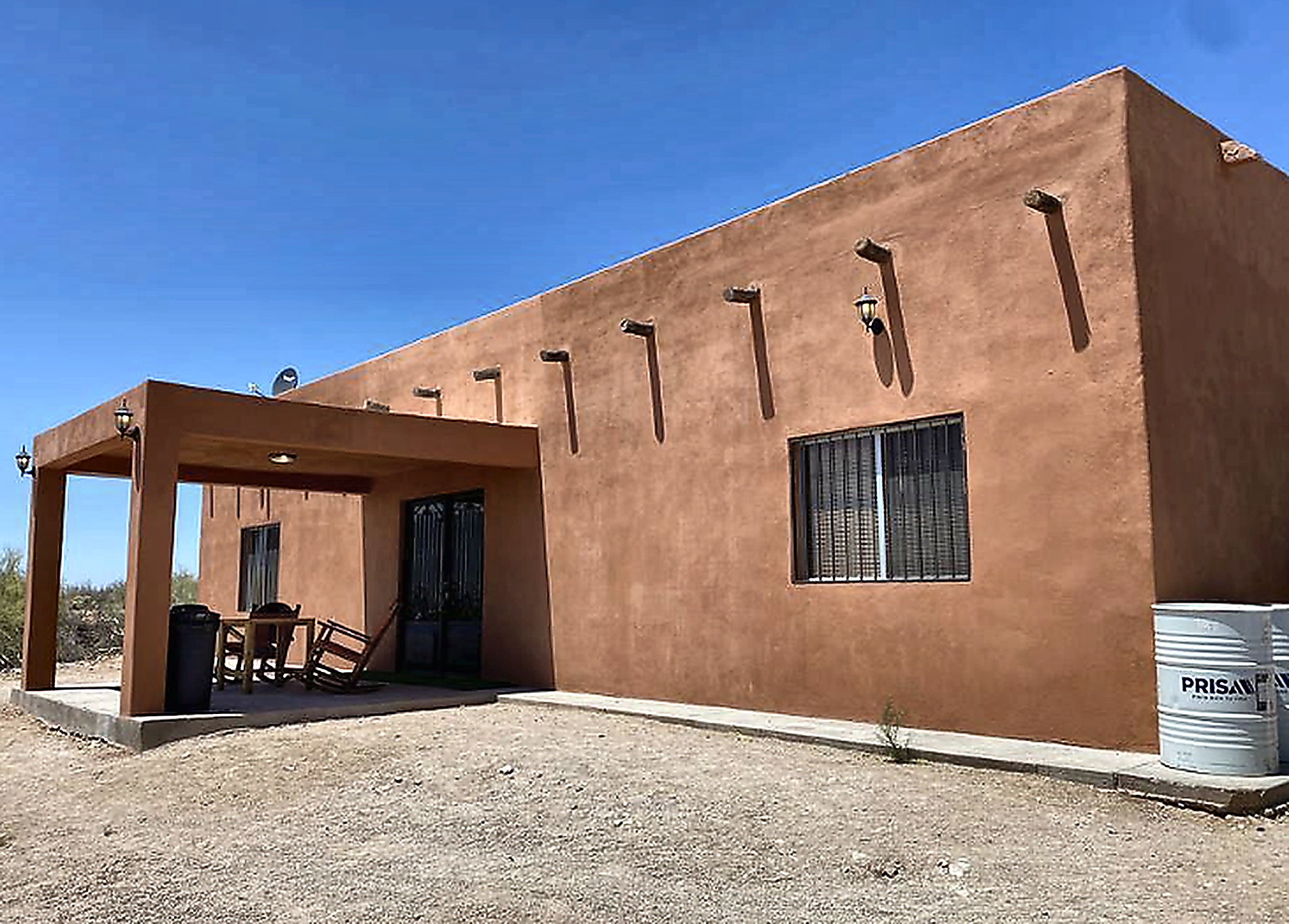 Adobe ranch lodge exterior under clear Sonora desert sky