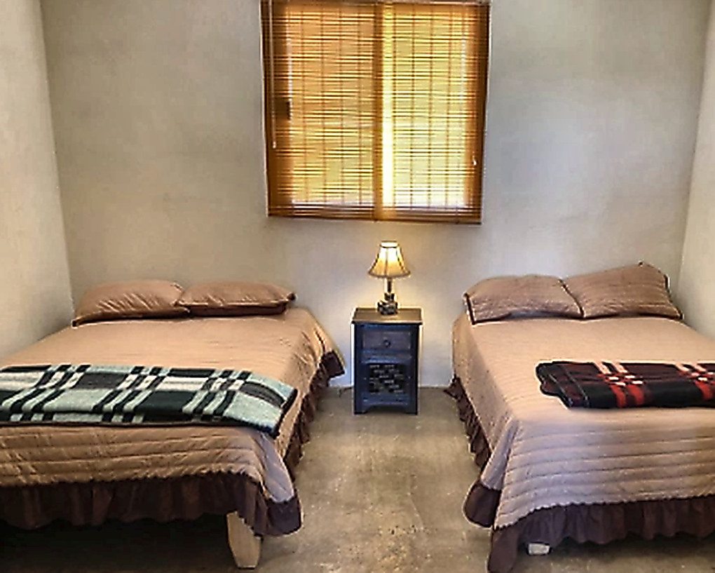 Twin-bed guest room at the Sonora ranch lodge