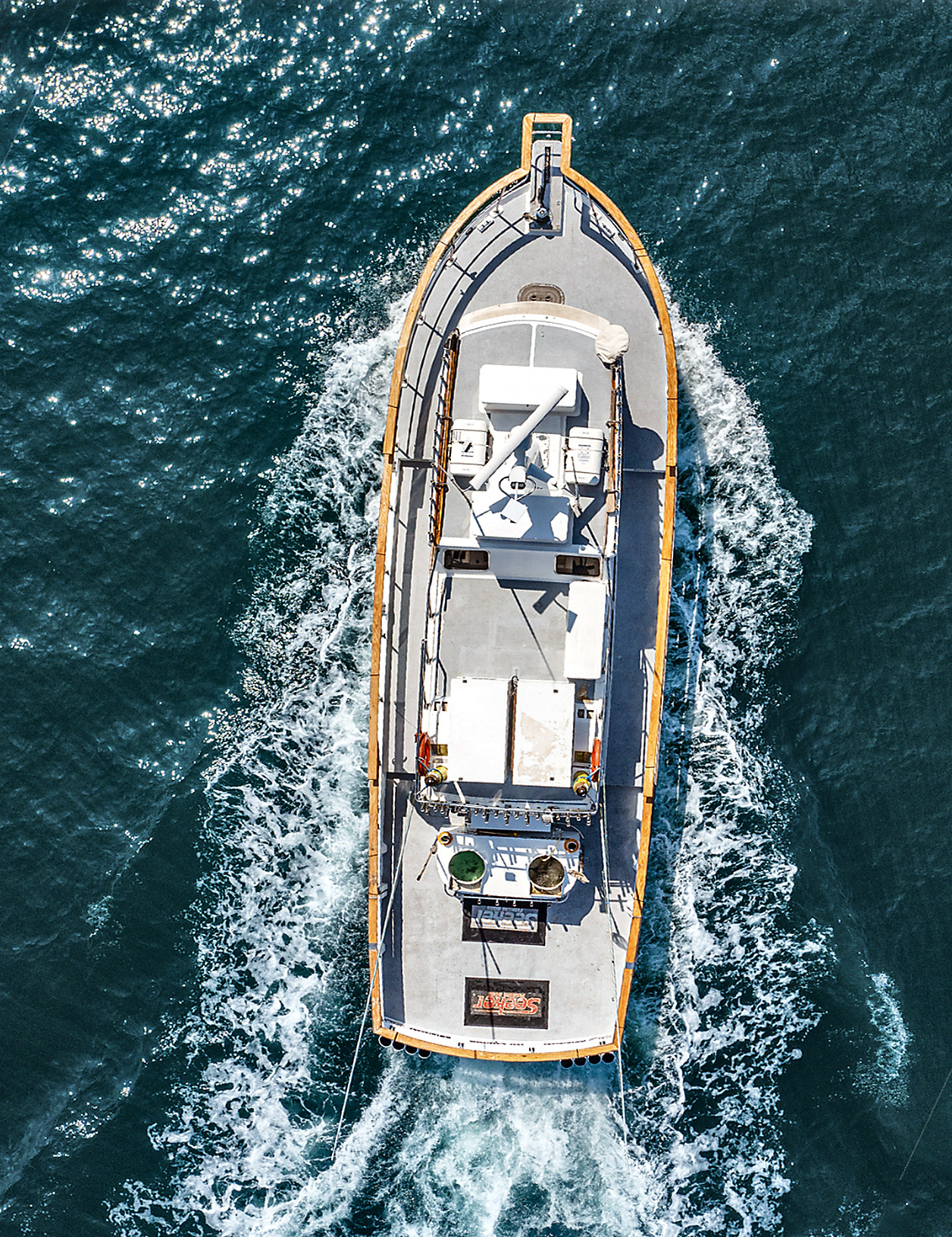 Overhead drone view of the sportfisher underway through blue Pacific water
